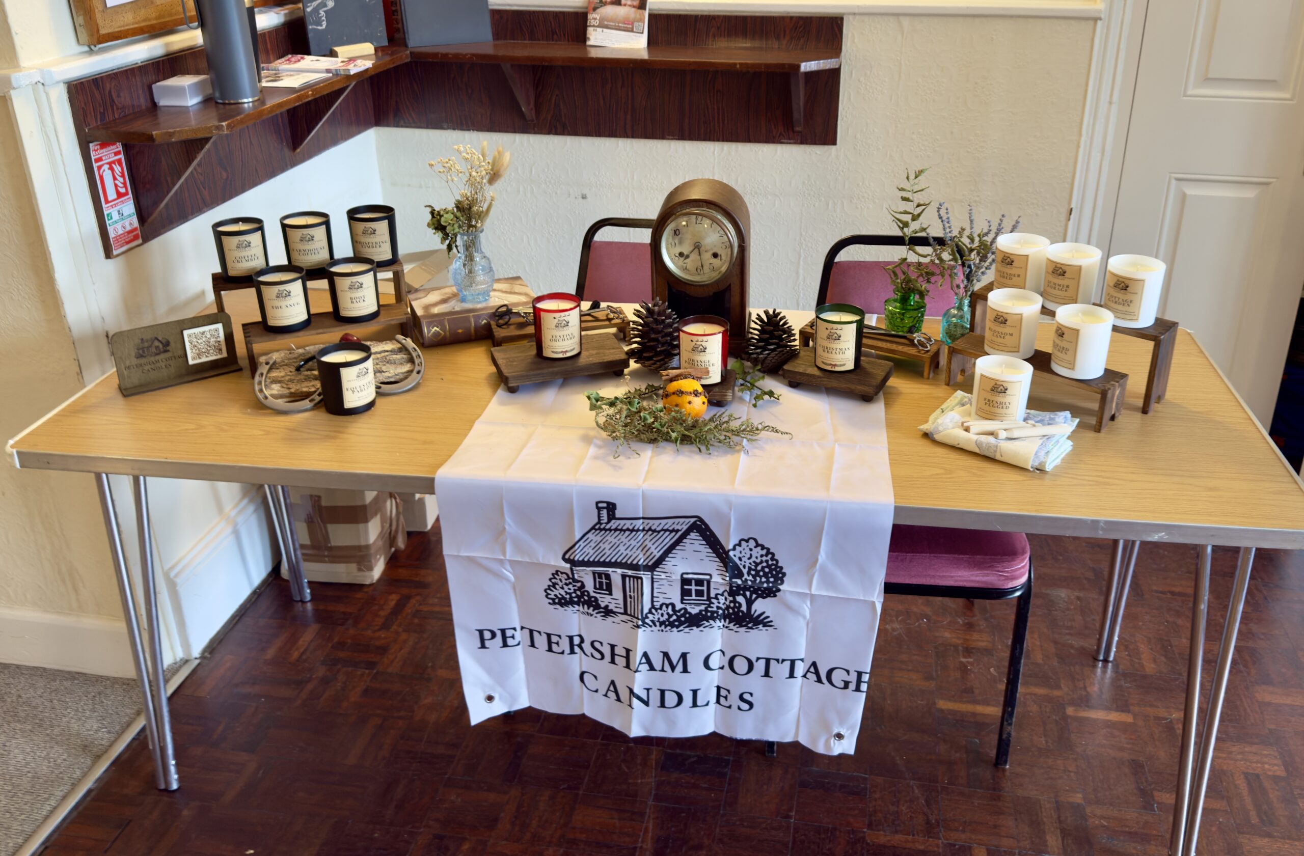 Petersham Cottage Candles stall at Bloxworth craft fair, showing a cosy cottage-style display of hand-poured candles
