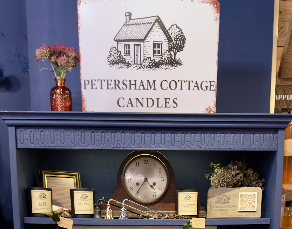 Petersham Cottage Candles arranged on a bookshelf display at 1855 in Sturminster Newton, Dorset