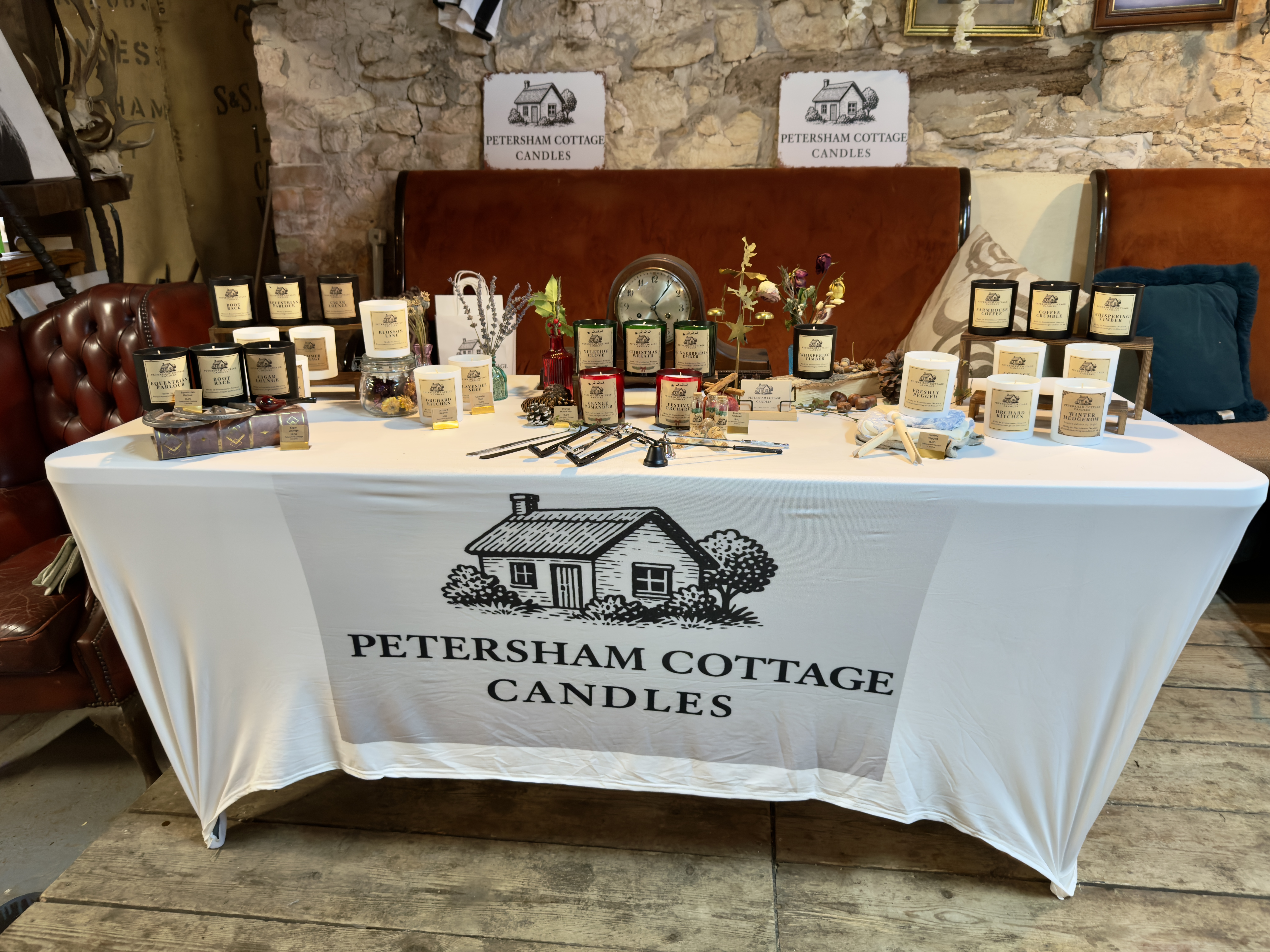Petersham Cottage Candles stall at Laycock Cider Christmas Market with rows of hand-poured Christmas candles and rustic festive décor.