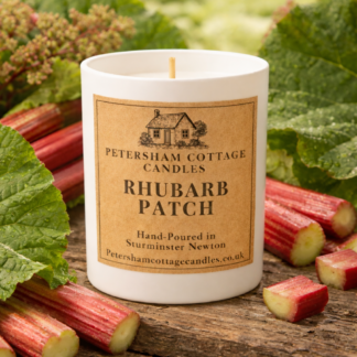Rhubarb Patch candle by Petersham Cottage Candles surrounded by fresh rhubarb stalks